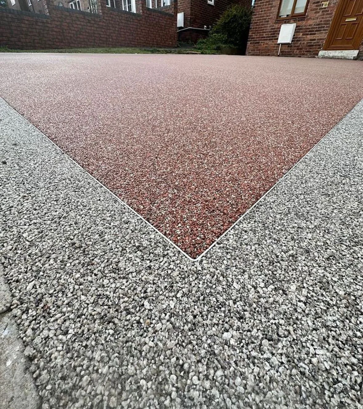 Red resin inset meeting a silver-grey aggregate surface